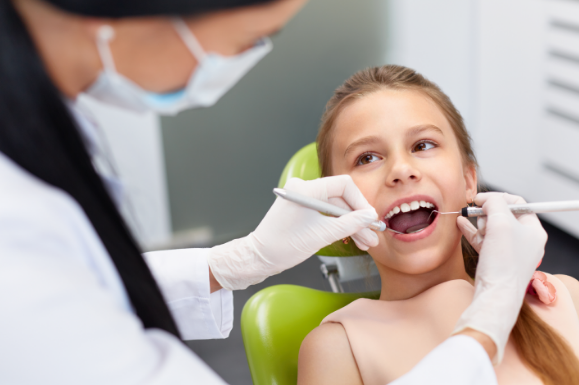 A picture of a girl in the dentist chair