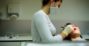 Photo of a dentist removing wisdom teeth