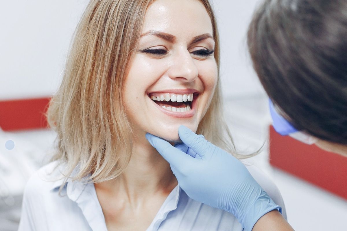 dentist performing a cosmetic dental checkup